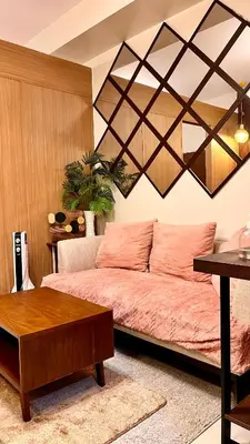 a bedroom with a bed and a table at M&B Staycation in Manila