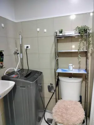 a small bathroom with a sink and a toilet at Seaside Serenity in Manila