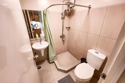 a small bathroom with a toilet and a sink at Artsy 110sqm 2br in MOA 200mbps Wifi XBOX Printer in Manila