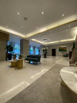 a living room with a couch and a table at Fame residences in Manila