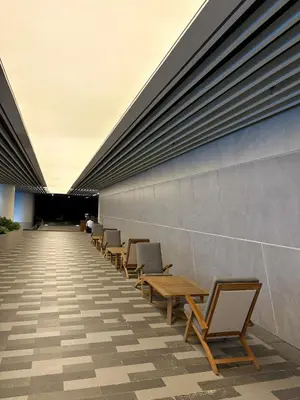 a row of chairs and tables on the side of a building at 1LDK Air Studio in Makati City in Manila
