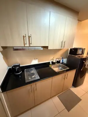 a kitchen with a sink and a counter top at LALAROOMS - with Manila Bay Sunset View in Manila