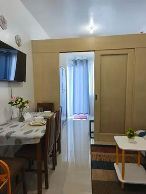 a dining room with a table and some chairs at City Staycation Condo-SM Jazz in Manila