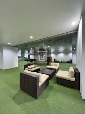a living room with couches and a green carpet at Shore 3 Tower 1 Condo staycation near MOA - DT in Manila