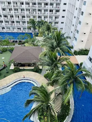 an aerial view of a resort with palm trees and a swimming pool at The Cozy Corner in Manila