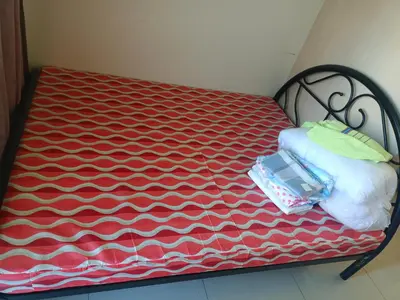 a bench with a red and white blanket on it at Sea Residence Tower EF in Manila