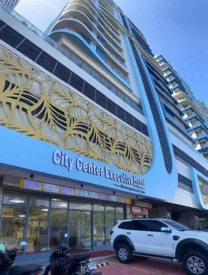 a white suv parked in front of a city center exercising place at City Center Executive Hotel-Near Manila Airport and PITX in Manila