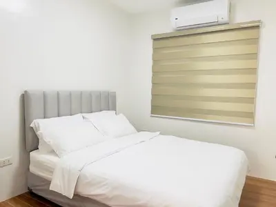 a bedroom with a white bed and a window at CASA GUADA - Villa & Pool House Staycation in Postema