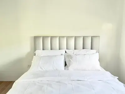 a white bed with white sheets and pillows at CASA GUADA - Villa & Pool House Staycation in Postema