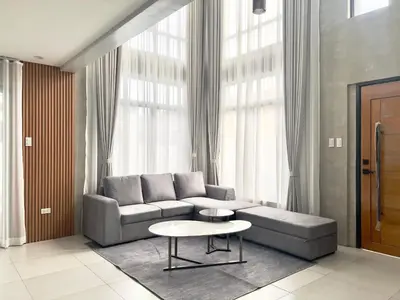 a living room with a couch and a table at CASA GUADA - Villa & Pool House Staycation in Postema