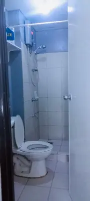 a bathroom with a toilet and a shower stall at Avida sm sucat paranaque in Manila
