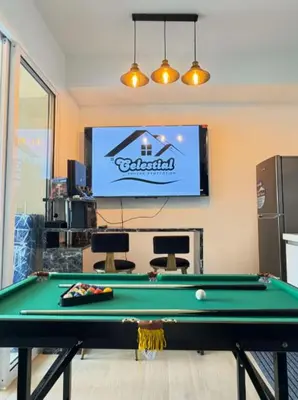 a living room with a pool table and a television at Celestial Sphere Staycation at Azure Urban Resort Residences in Manila