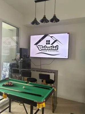 a room with a pool table and a sign on the wall at Celestial Sphere Staycation at Azure Urban Resort Residences in Manila