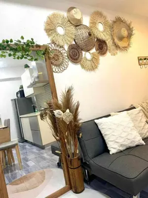 a living room with a couch and a mirror at Aerith's Haven Azurecation in Manila