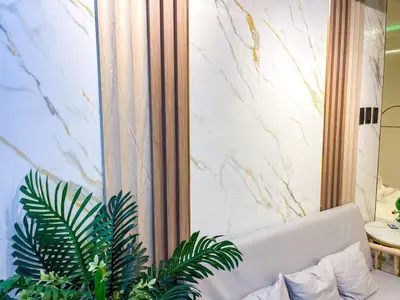 a white couch in a room with plants at Cozy & Chic 1BR near Mall of Asia - S Residences in Manila