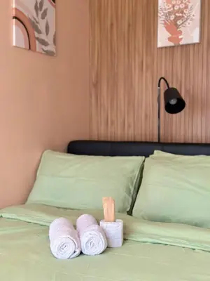 a bed with three rolls of towels on it at Azure staycation by marco in Manila