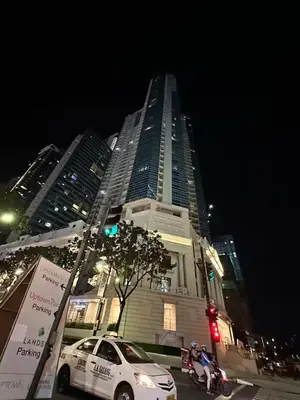 a white car parked in front of a tall building at Uptown Parksuite 1 BR Tower 2 BGC Taguig in Manila