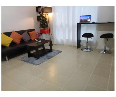 a living room with a couch and a table at 2BR PIONEER Woodland Boni,Mandaluyong connected to Boni MRT station in Manila