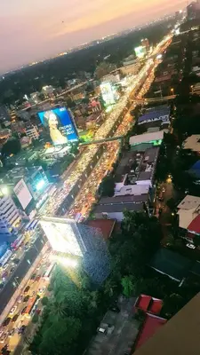 an overhead view of a city with traffic at night at Millionaire Makati Brio Tower in Manila