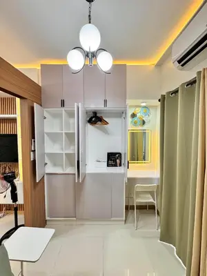 a kitchen with a refrigerator and a table at MJM Cityscape at Red Residences in Manila