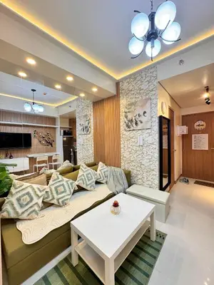 a living room with a couch and a table at MJM Cityscape at Red Residences in Manila