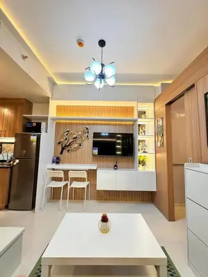 a kitchen with a white table and a refrigerator at MJM Cityscape at Red Residences in Manila