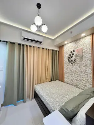 a bedroom with a bed and a ceiling fan at MJM Cityscape at Red Residences in Manila
