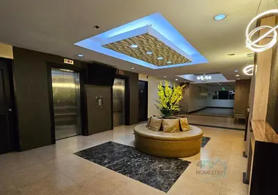 a lobby with a round couch in the middle of a building at Spacious & Cozy 1-Bedroom, Sleeps 2-4 in Manila