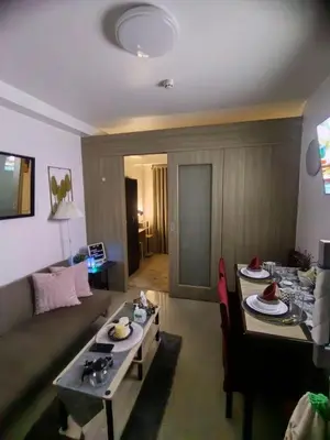 a living room with a couch and a table at Mall of Asia's Staycation in Manila