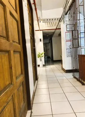 an empty hallway in an office building with a door at Circuit Suites in Manila