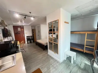a small room with a bed and a bedroom at Ortigas Condotel near Robinsons Galleria with free pool in Manila
