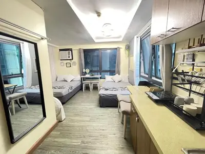 a small room with two beds and a living room at ADB Avenue Tower GOOD FOR 5 PAX in Manila