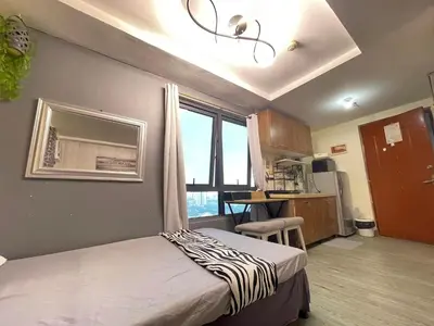 a bedroom with a bed with a zebra blanket on it at ADB Avenue Tower GOOD FOR 5 PAX in Manila