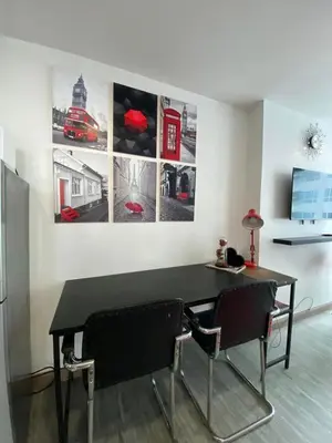 a dining room with a black table and two chairs at Modern Condotel in Ortigas good up to 8 pax in Manila