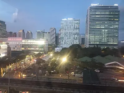 a city skyline at night with buildings and street lights at Deca Cubao Budget Condo by Ashti in Manila