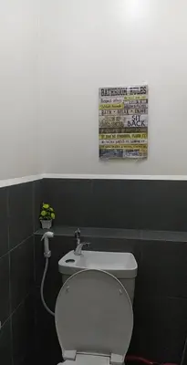 a bathroom with a white toilet and a sink at Deca Cubao Budget Condo by Ashti in Manila