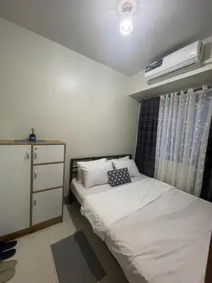 a bedroom with a bed and a dresser and a window at Gen Travel Hub in Manila
