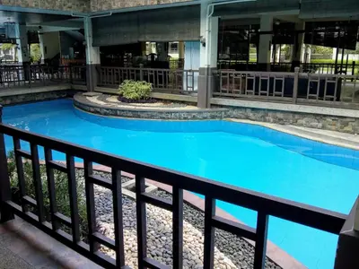 a swimming pool with blue water in a building at Millionaire Tropical Paradise Penthouse Royal Palm in Manila