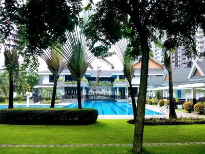 a resort with a swimming pool and palm trees at Millionaire Tropical Paradise Penthouse Royal Palm in Manila