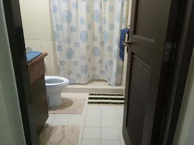 a bathroom with a toilet and a shower curtain at Millionaire Tropical Paradise Penthouse Royal Palm in Manila