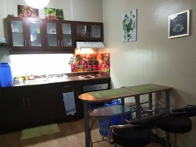 a small kitchen with a table and a counter at Millionaire Tropical Paradise Penthouse Royal Palm in Manila