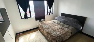 a small bedroom with a bed and a window at DPMC Stay and Play Vacation Unit in Cainta