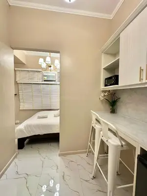 a bedroom with a desk and a bed in a room at Studio Two Condominium, Alabang AMBER -Fiber WI-FI Netflix ready in Manila