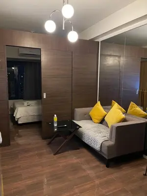 a living room with a couch and a table at Destina, 100Mbps at Air Residences, Makati, MetroManila, Netflix in Manila