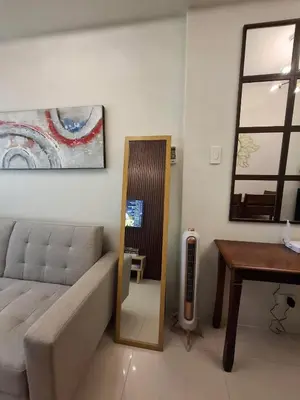 a living room with a couch and a table at Stylish and Comfy Condominium in Manila