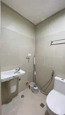 a bathroom with a toilet and a sink at Staycation Bliss at Fame in Manila
