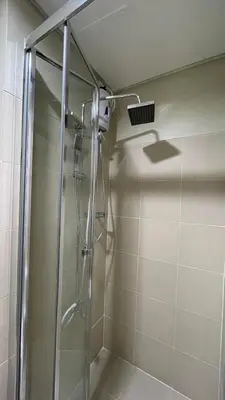 a shower in a bathroom with a glass shower stall at Staycation Bliss at Fame in Manila