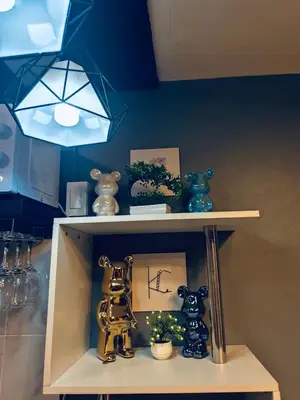 a shelf with figurines on it in a kitchen at Cloves Den Binangonan Your Ultimate Cinema Date in Binangonan