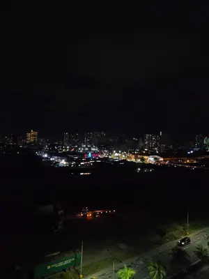 a view of a city at night with lights at Cozy Corner at Shore 2 in Manila