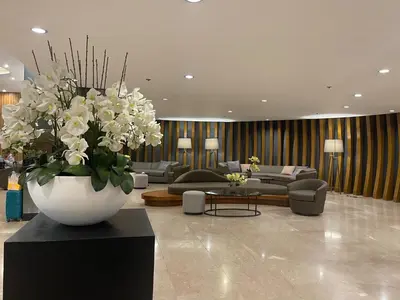 a living room with a large vase of white flowers at SMDC SHORE 1 Residences, TOWER A in Manila